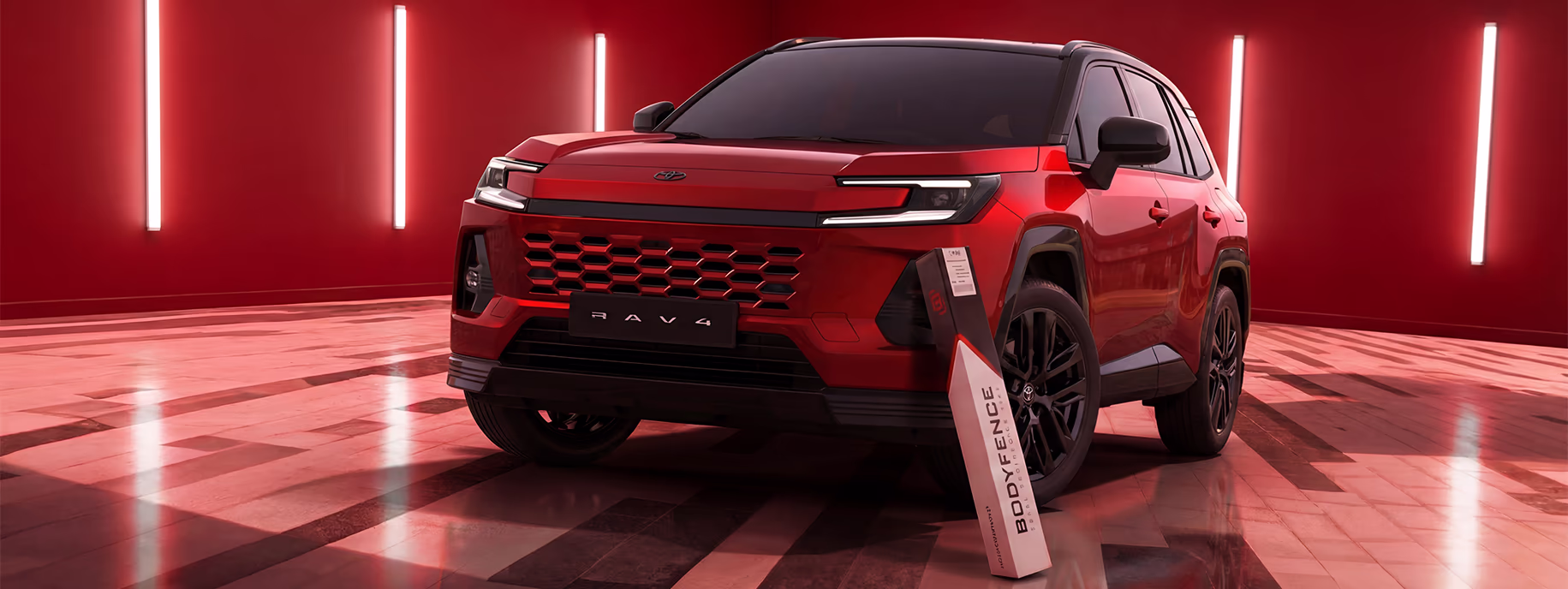 عن HEXIS – أفضل PPF في السعودية | اسار أوتو الدمام وكيل HEXIS BODYFENCE الرسمي تويوتا RAV4 حمراء أمام خلفية حمراء مع علبة منتج HEXIS BODYFENCE لحماية طلاء السيارة.